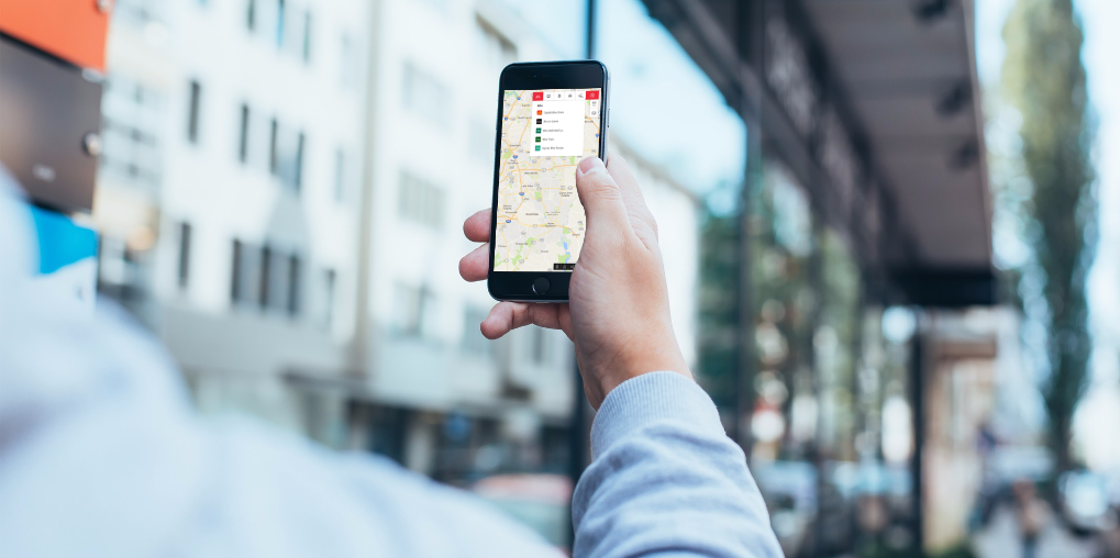 Mobile phone in hand using trip planning app